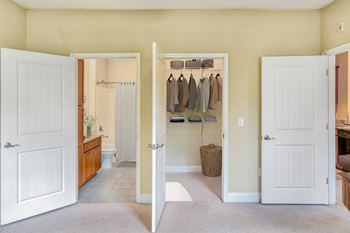 A room with a white door and a white wall.
